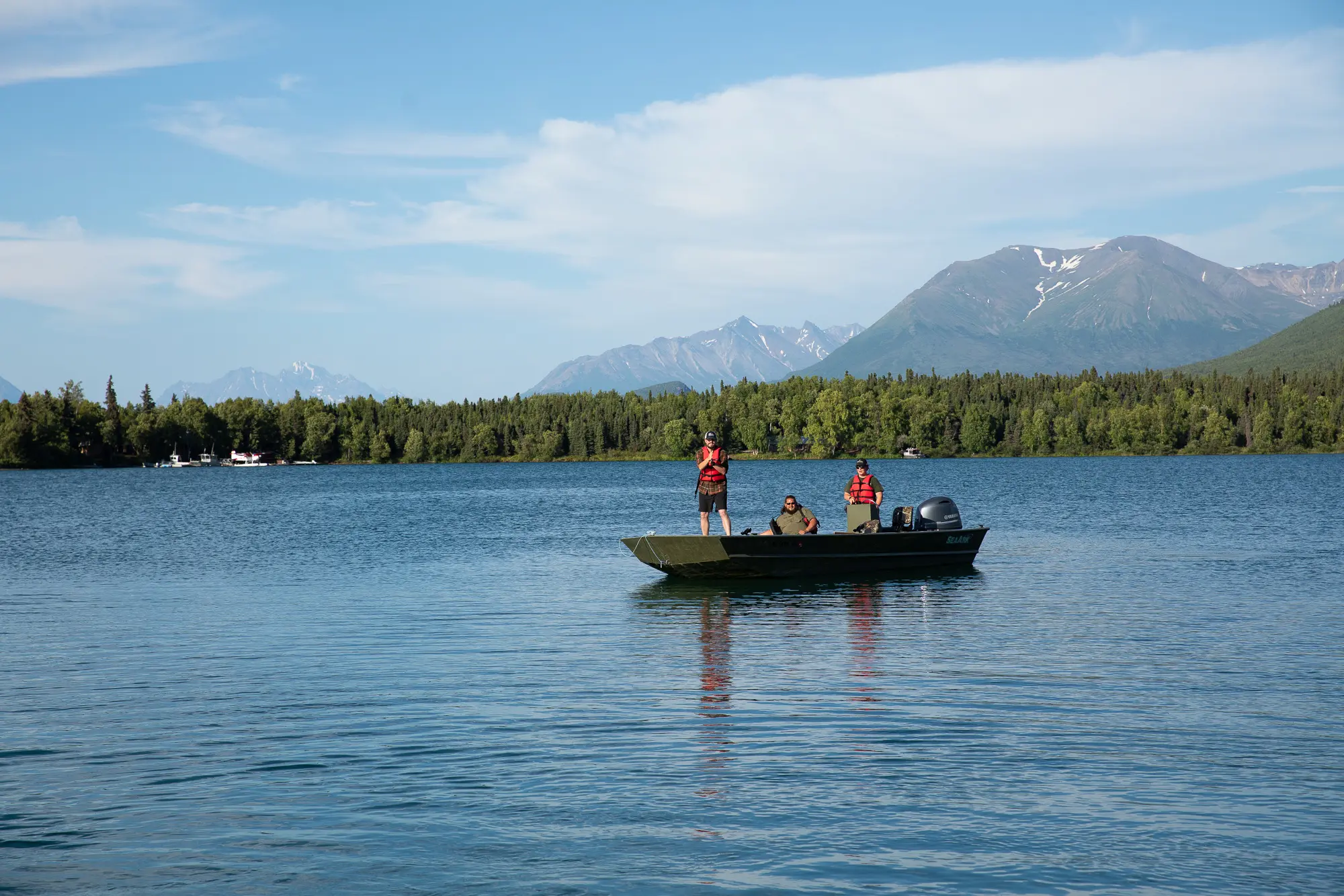 A small boat crossing a mountain lake