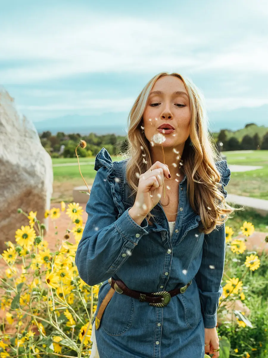 A traveler standing in a field of flowers
