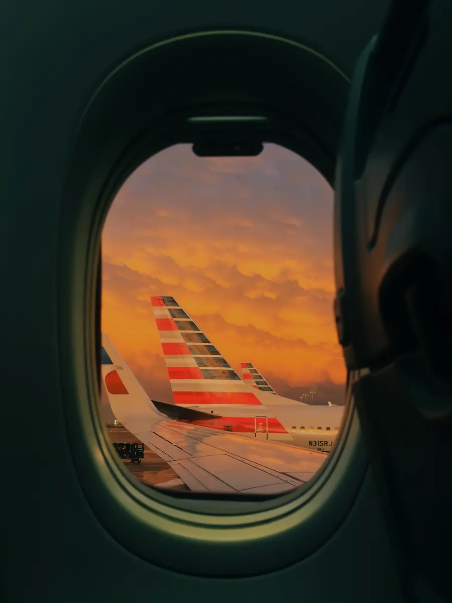Sunset and an airplane seen through a window