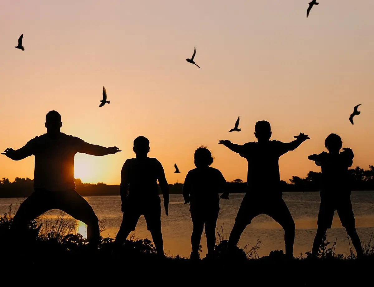 Figures moving at sunset
